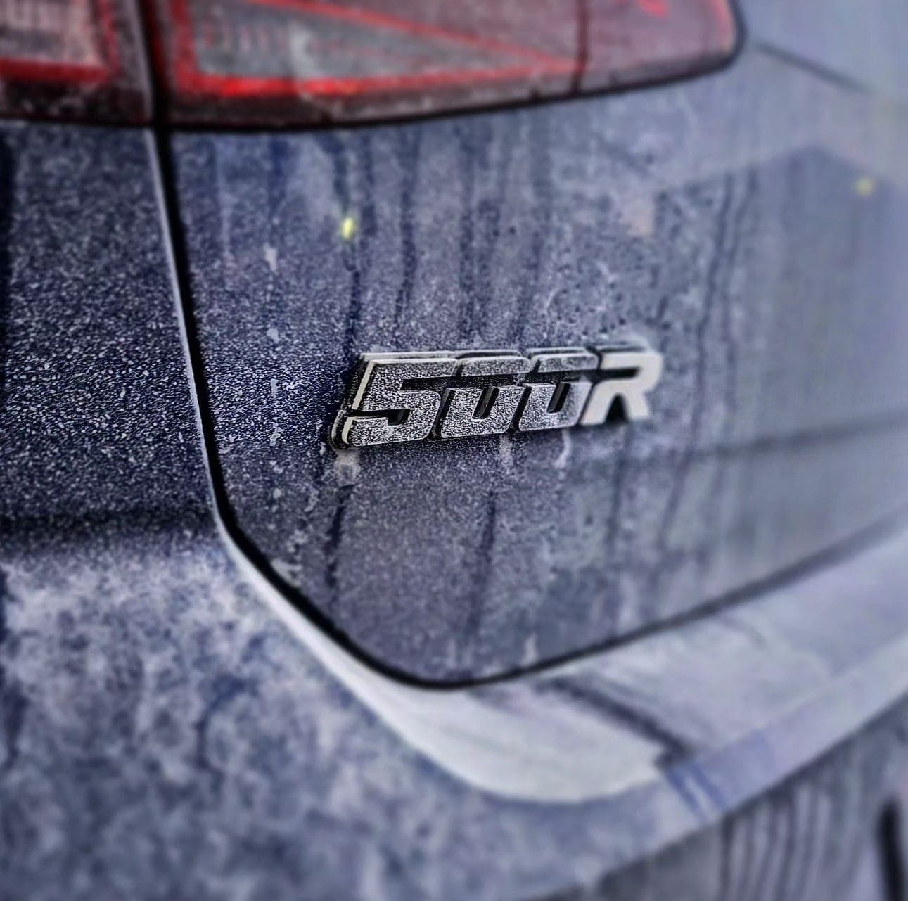 Badge Studio 500R badge fitted on a Volkswagen Golf R – customer photo showing premium gloss black finish